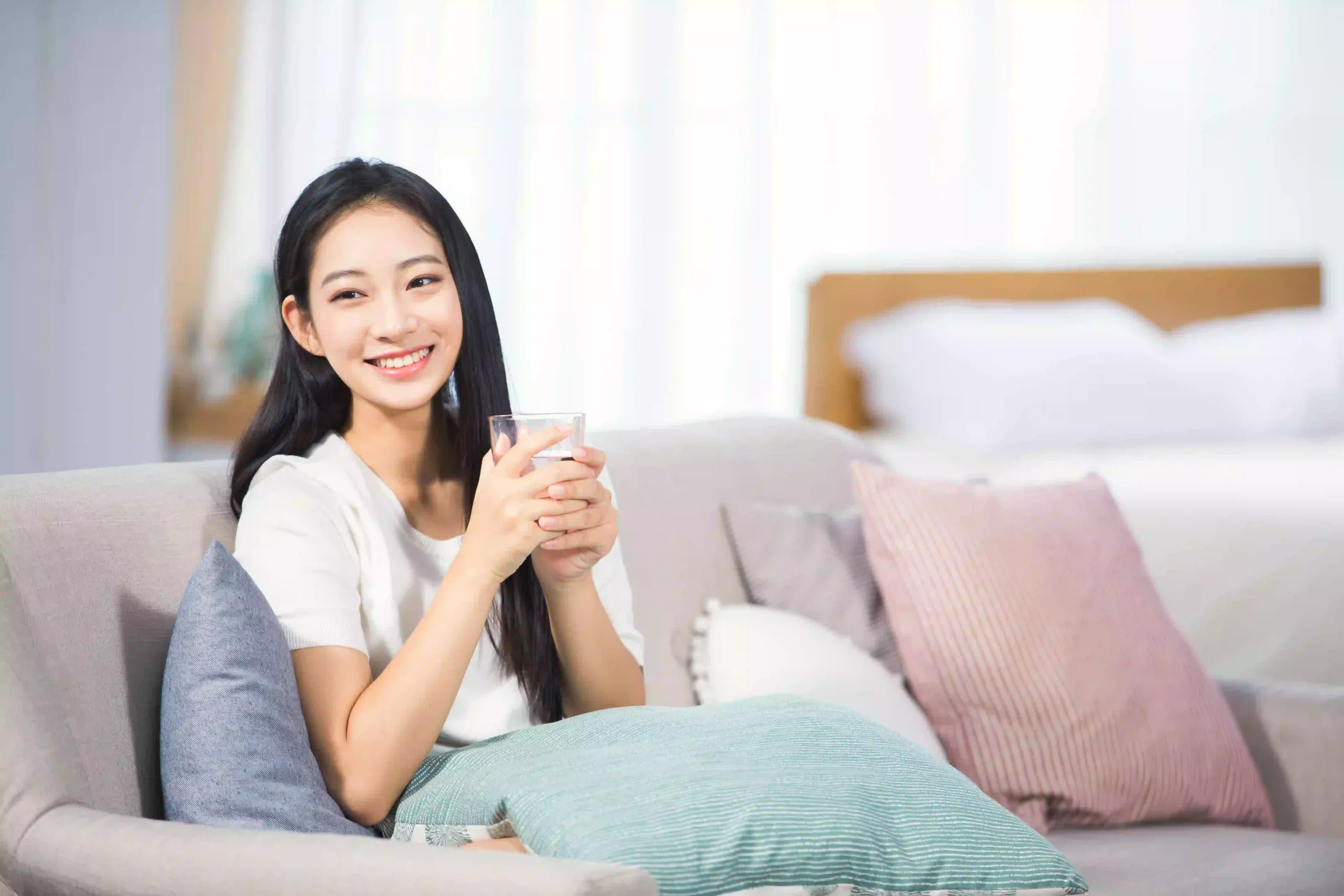 Lovepik com 501373001 female sitting on the couch drinking water scaled